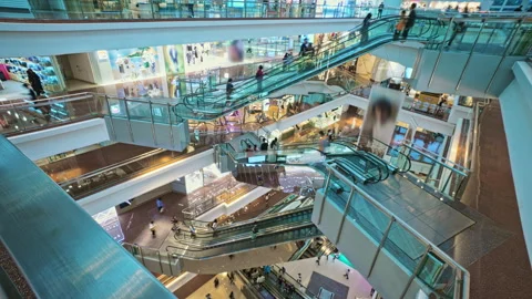 Bright Multi-Level Shopping Mall Interior Revealing Escalators Video stock 312367280