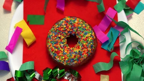 Bright multicolored donut top view. confetti around 스톡 동영상 82879208