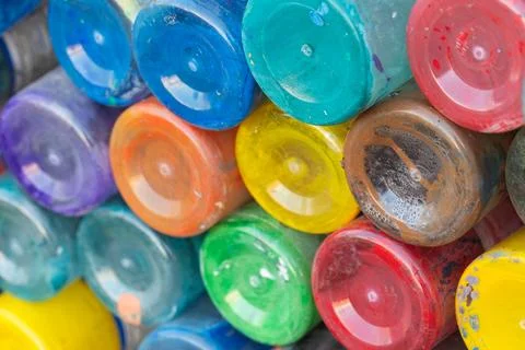 Bright, multicolored paint jars stacked in a composition 스톡 사진