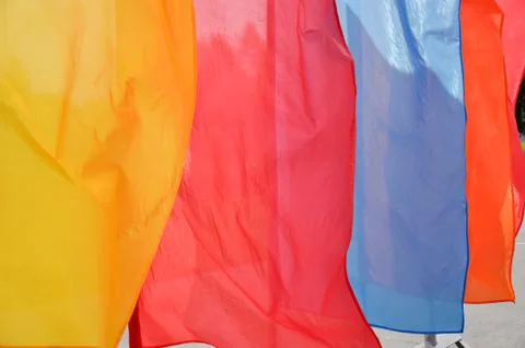 Bright multicolored vertical flags on flagpoles Stock Photos