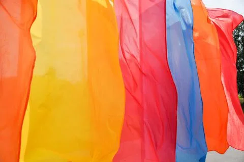 Bright multicolored vertical flags on flagpoles Stock Photos