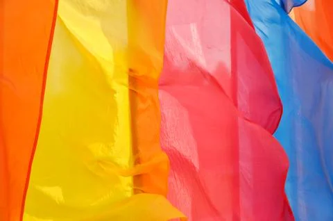 Bright multicolored vertical flags on flagpoles Stock Photos