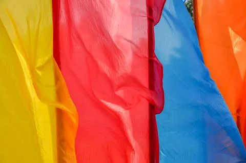 Bright multicolored vertical flags on flagpoles Stock Photos