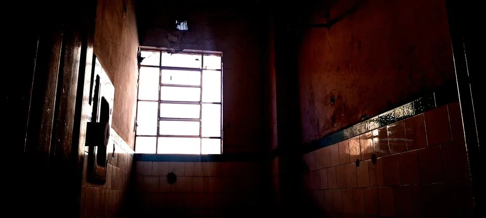 Bright natural light streaming through a dusty old grid window pane Stock Photos