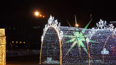 Bright night lights decorations shining on New Year alley archway at festive Stock Footage 100142202