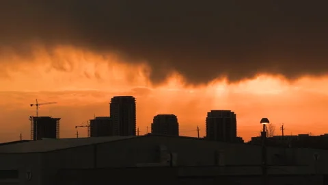 Bright orange and red sunset with dark clouds in sky Stock-Footage 154206528