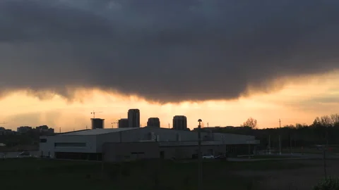 Bright orange and red sunset with dark clouds in sky Stock Footage 154209265