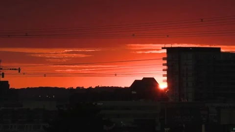 Bright orange and red sunset with dark clouds in sky 動画素材 156683285