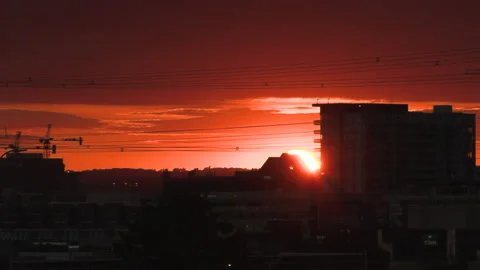 Bright orange and red sunset over the lake by the beach on hot summer evening Видео 156706489