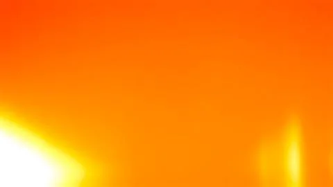 Bright orange background, with soft white, and yellow light leaks Stock Photos