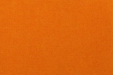 Bright orange background from textile material. Fabric with natural texture. Stock Photos