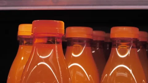 Bright orange beverage bottles Stock Footage 306179037