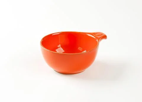 Bright orange ceramic measuring cup with handle Photos