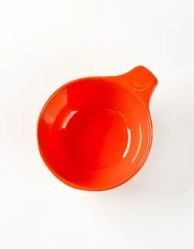 Bright orange ceramic measuring spoon on table Stock Photos