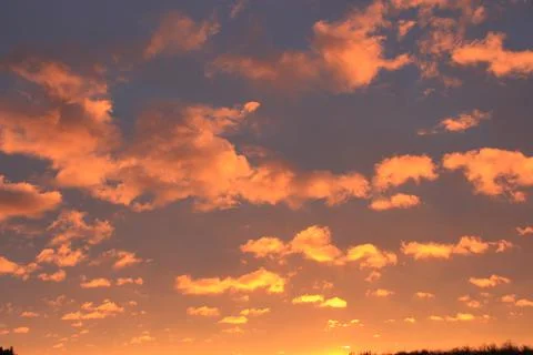 Bright Orange cloud pattern in evening sky Stock Photos