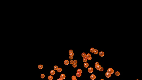 Bright orange faceted orbs drift slowly upward across a solid dark field Stock Footage 344910107