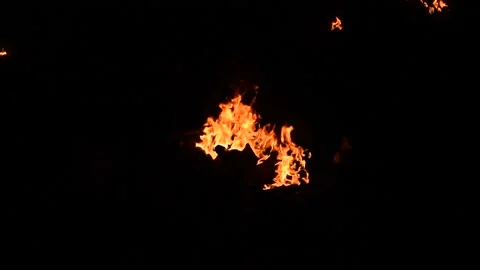 Bright orange fire burning isolated against a pitch black background Stock Footage 133099312