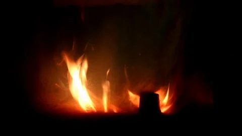 Bright orange fire flames and wooden log in fireplace at home Video stock 128476062
