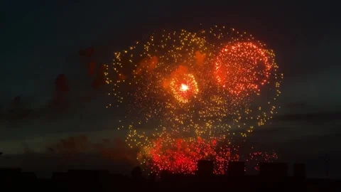 Bright orange fireworks exploding in night sky Stock Footage 339789749