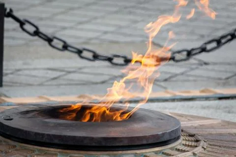 Bright orange flame in fire pit at Arc de Triomphe Stock Photos