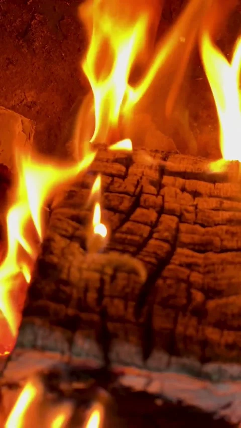 Bright orange flames burning a log in a fireplace Stock Footage 331973554