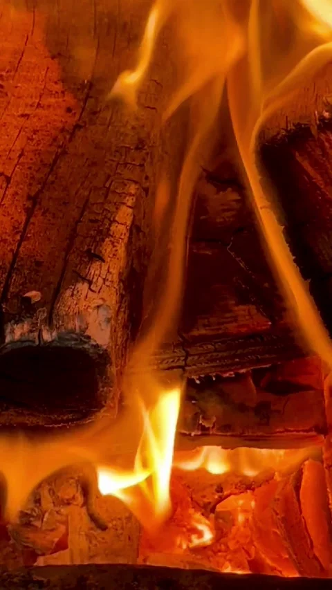 Bright orange flames flicker over burning logs in fireplace Stock Footage 331983250