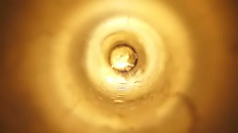 A bright orange flash of fire with sparks inside a metal pipe Stock Footage 130541516