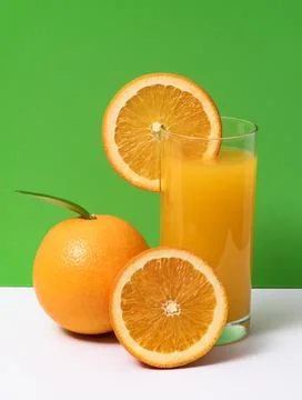 Bright orange fruit slice. Fresh orange citrus drink. Juicy orange juice gl.. Stock Photos