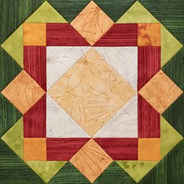 Bright orange-green geometric patchwork block from pieces of fabrics 库存照片