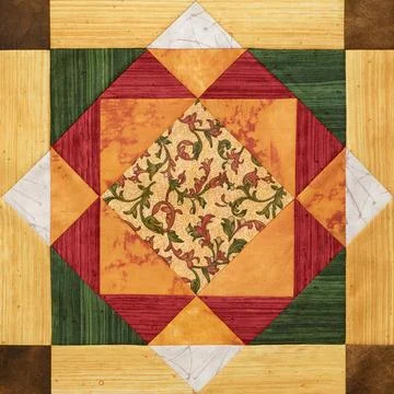 Bright orange-green geometric patchwork block from pieces of fabrics 스톡 사진