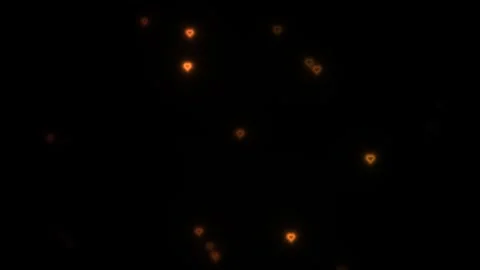 Bright orange hearts float against a dark background in Stock Footage 338234341