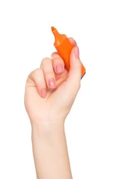 Bright orange highlighter held by hand with perfectly manicured nails against a Stock Photos