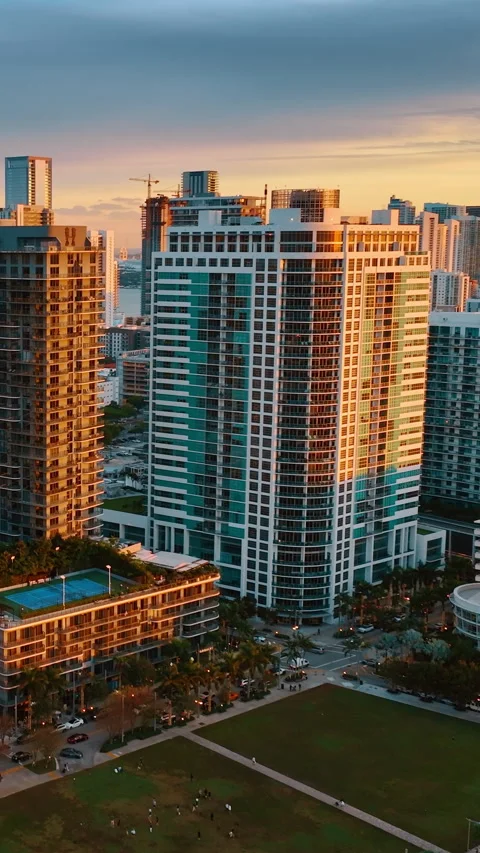 Bright orange light of setting sun on the facades of the high-rise buildings. Stock Footage 297623700