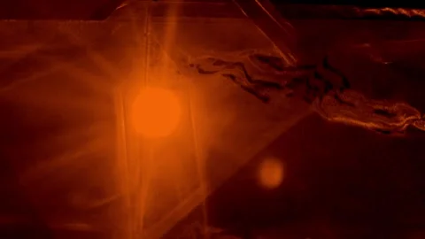 Bright orange light source creating a dramatic starburst effect against a d.. Stock Footage 346559524