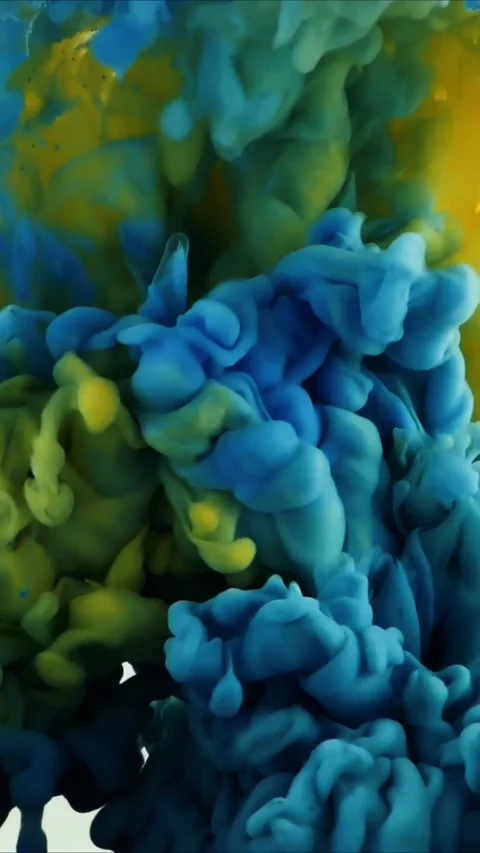 Bright orange liquid ink dropping into clear water creating abstract swirling Stock Footage 347691972