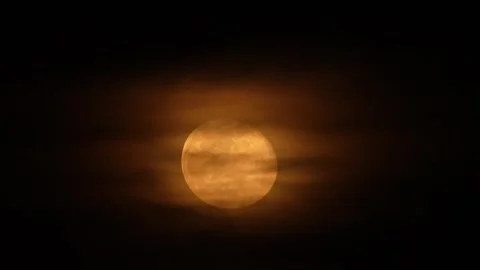 Bright orange moon shining through passing night clouds. Stock Footage 340292851
