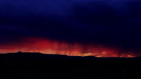 Bright orange New Mexico sunset under indigo storm clouds Stock Footage 44212437
