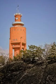 A bright orange observation tower set in the surrounding nature Stock Photos