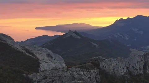 A bright orange sunset over a coastal mountain range. Amazing spectacle aerial Stock Footage 170645300