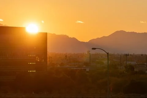 Bright orange sunset in Phoenix with a view of the sun going down behind th.. Stock Photos