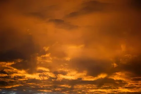 Bright orange sunset sky with clouds over the horizon Stock Photos