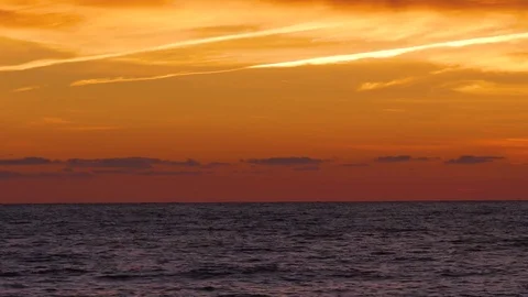 Bright orange sunset sky over waving sea surface. Splendid seascape Video stock 80267119
