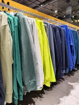 Bright outerwear collection hanging in a sporting goods environment present.. Stock Photos