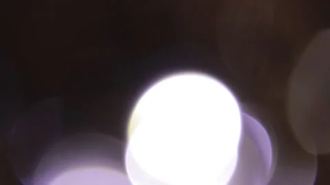 The bright, overlapping bokeh in the blackness Видео 309353724