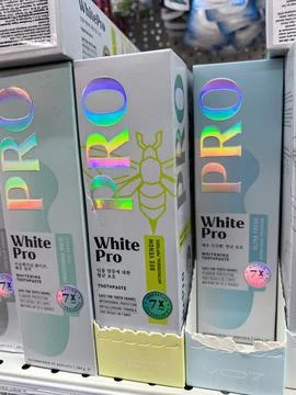 Bright packaging showcases unique features of White Pro toothpaste Stock Photos