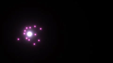 Bright particles float around a central glow in a dark Видео 338194422