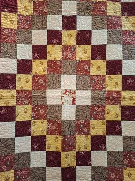 Bright patchwork quilt with floral and geometric patterns shows cozy home d.. 写真素材
