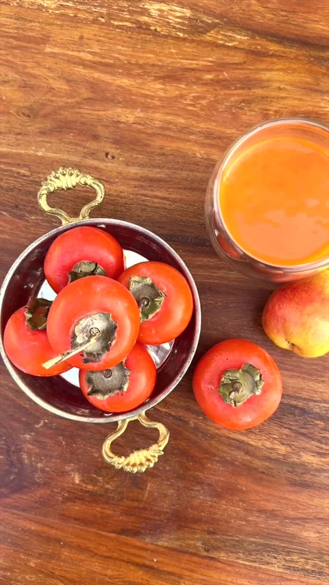 Bright persimmons arranged with juice create vibrant healthy visuals, persimmons Stock-Footage 295441986