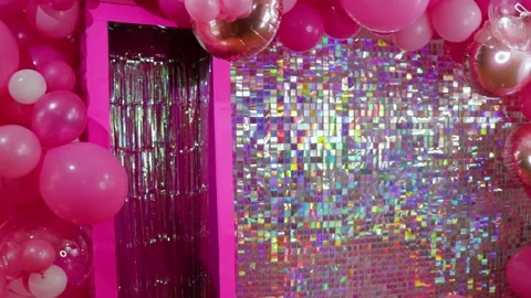 Bright pink and silver party decor with balloons and shimmering backdrop Stock Footage 283655944