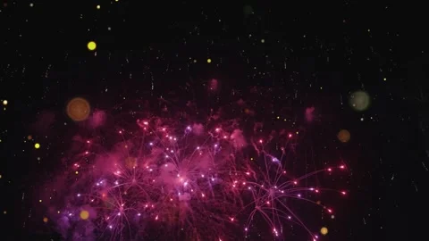 Bright pink fireworks exploding in the night sky during a festive celebration Stock Footage 345832049